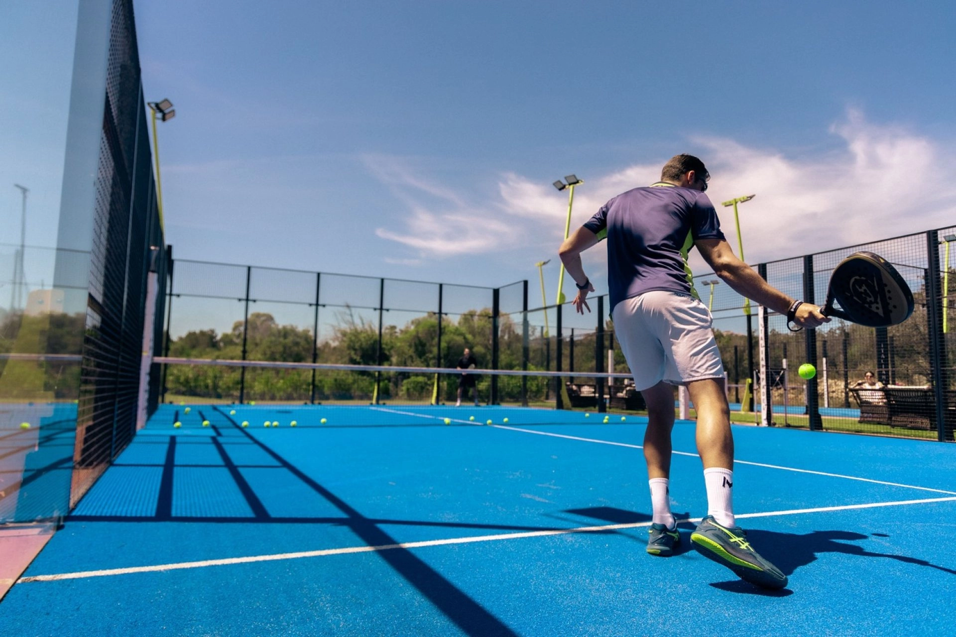 A beginner padel player on court practicing their technique